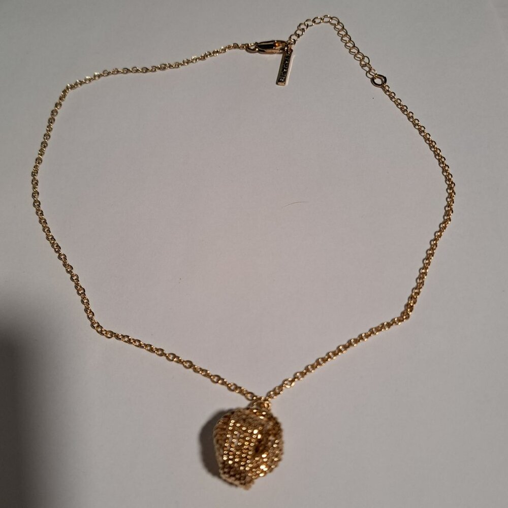 Tahari gold tone necklace with knot pendant